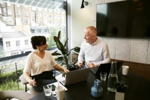 Man-and-woman-talking-in-office-setting-consulting